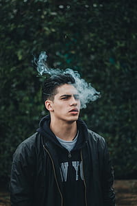 man standing while smoking thumbnail