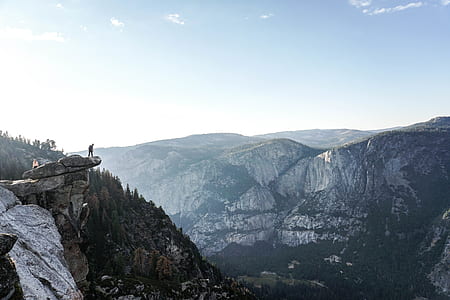 person standing on edge of rock thumbnail
