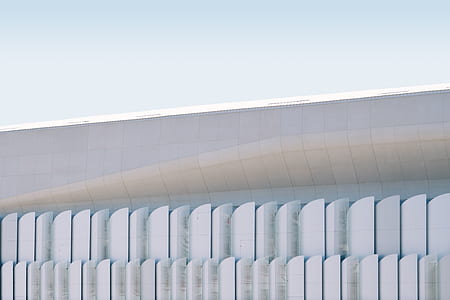 photo of white concrete building under clear blue sky thumbnail