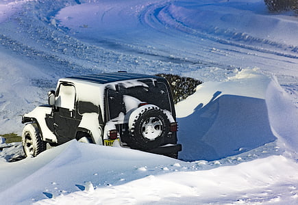 black SUV covered with snow thumbnail