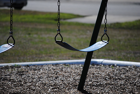 photography of black metal swing at daytime thumbnail
