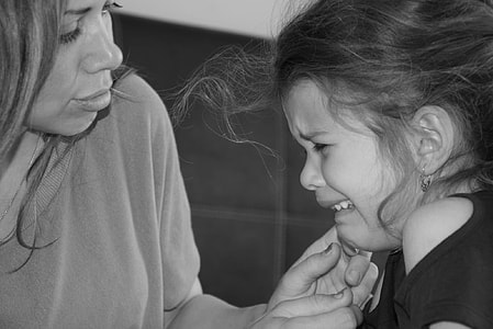 woman holding chin of crying girl thumbnail