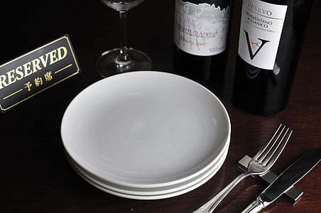 plate beside wine bottles thumbnail