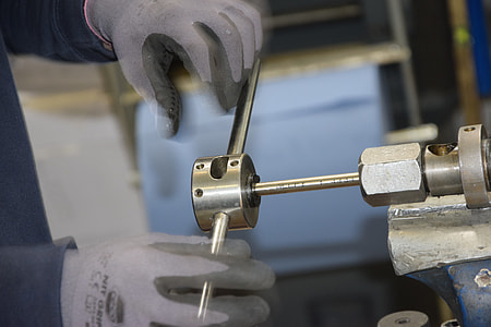 man turning a gray steel hand tool thumbnail