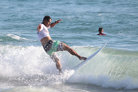 man surfing during daytime thumbnail