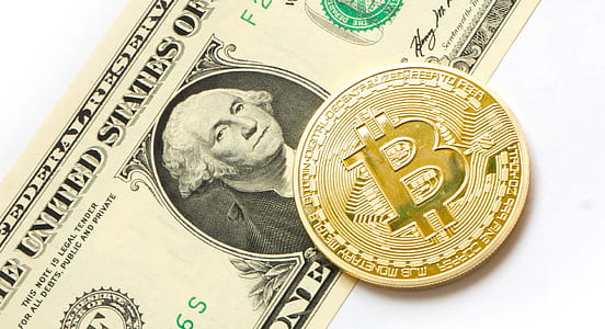 Bitcoin on top of U.S. dollar banknote thumbnail