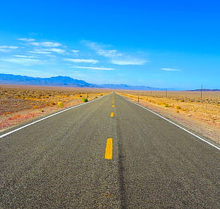 road near mountain under blue sky at daytime thumbnail