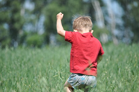 boy running on grass field thumbnail