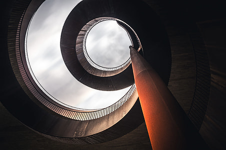 low angle photography of spiral stairs at daytime thumbnail