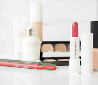 assorted-brand makeup palettes on white table thumbnail