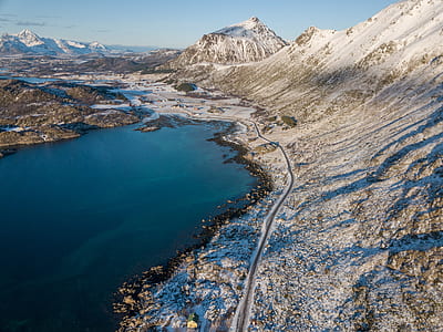 body of water surrounded by mountains thumbnail