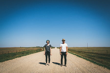 man and woman standing on middle of road thumbnail