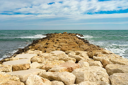 brown rocks on sea thumbnail