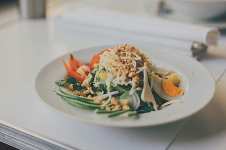 vegetable salad on round white ceramic plate thumbnail
