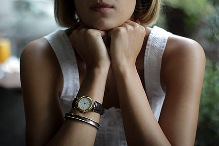sitting woman with both hands on chin thumbnail