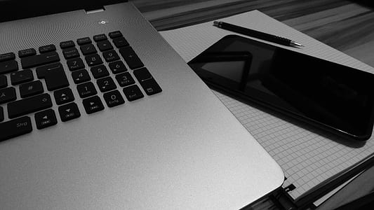 close up photo of laptop computer and phone thumbnail