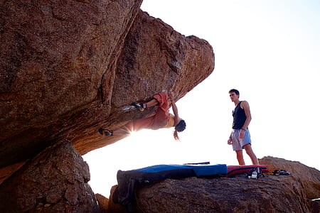 man and woman on rock hill at daytime thumbnail