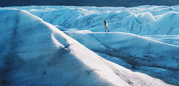 person standing on snow-covered hill during daytime thumbnail