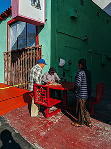 man sitting while playing board game thumbnail