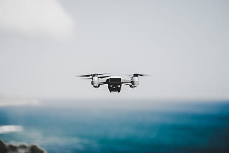 white and black drone hovering on air thumbnail
