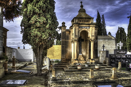 front view of cemetery surrounded with tombstones thumbnail