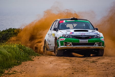 white and green Subaru Impreza WRC rally car during daytime thumbnail