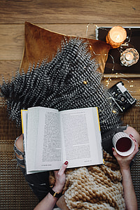 Woman drinking tea and reading book thumbnail