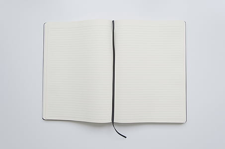 opened white book on white surface thumbnail