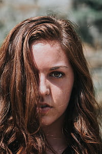closeup photography of woman under her brown hair thumbnail