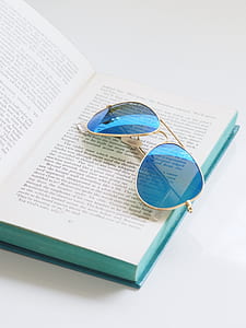 sunglasses on opened notebook thumbnail