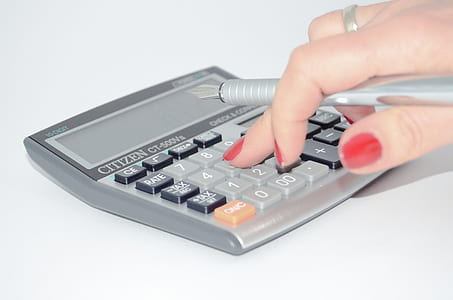 person pressing button on desk calculator thumbnail