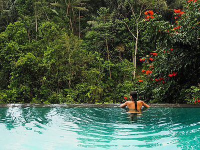 woman swimming at pool during daytime thumbnail