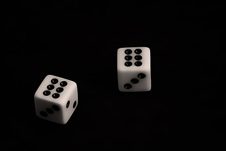 two white-and-black dice on black surface thumbnail