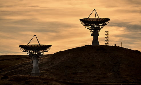silhouette of parabolic antennas during golden house thumbnail