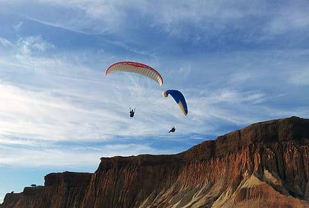 two person parachuting on mountain range thumbnail