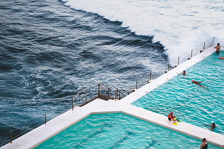 aerial view photography of swimming pool near ocean thumbnail