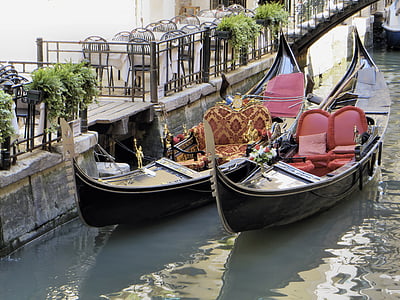 two brown wooden boats near concrete railings at daytime thumbnail