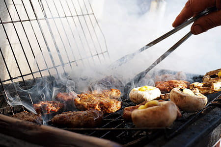 person using tong on grill meat thumbnail