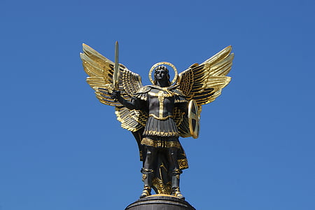 man with wings holding sword statue under blue skies at daytime thumbnail