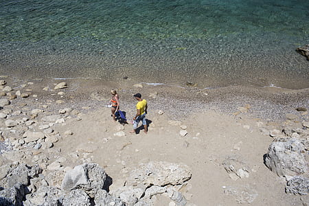 man and woman standing near seashore thumbnail