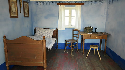 brown wooden bed and white mattress near table and window thumbnail