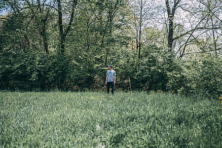 Photography of a Man Standing on Grass Field thumbnail