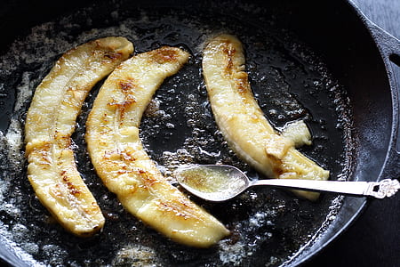 three fried bananas on frying pad with spoon thumbnail