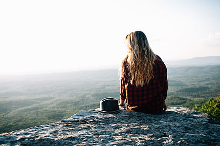 person siting in rock during daytime thumbnail