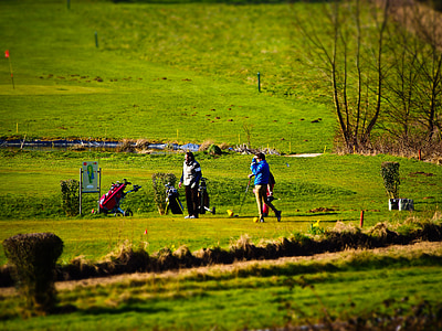 people playing golf during daytime thumbnail