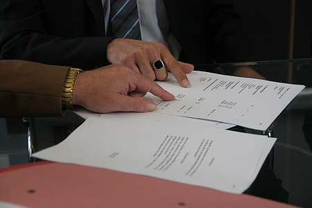 man in black blazer holding printing paper thumbnail