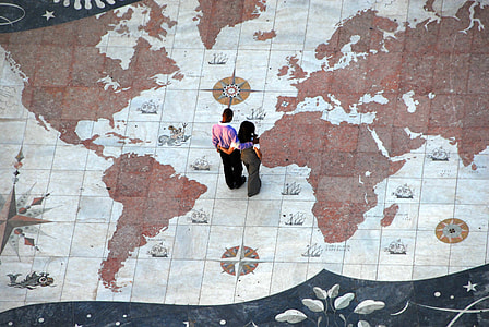 man and woman standing on white and brown map painted floor thumbnail