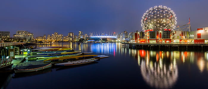 body of water near lighted city at night thumbnail
