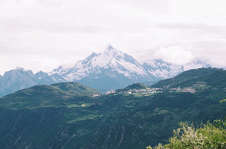 aerial view of green mountains covered with trees under clear sky thumbnail