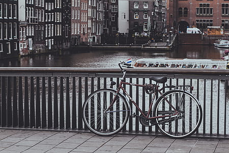 brown city bike beside gray steel hand track thumbnail